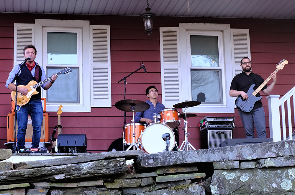Songwriter and guitarist Dylan Doyle [L] has been performing with drummer Mikiya Ito and bassist Ben Basile in a series of front porch concerts this summer for friends and neighbors.